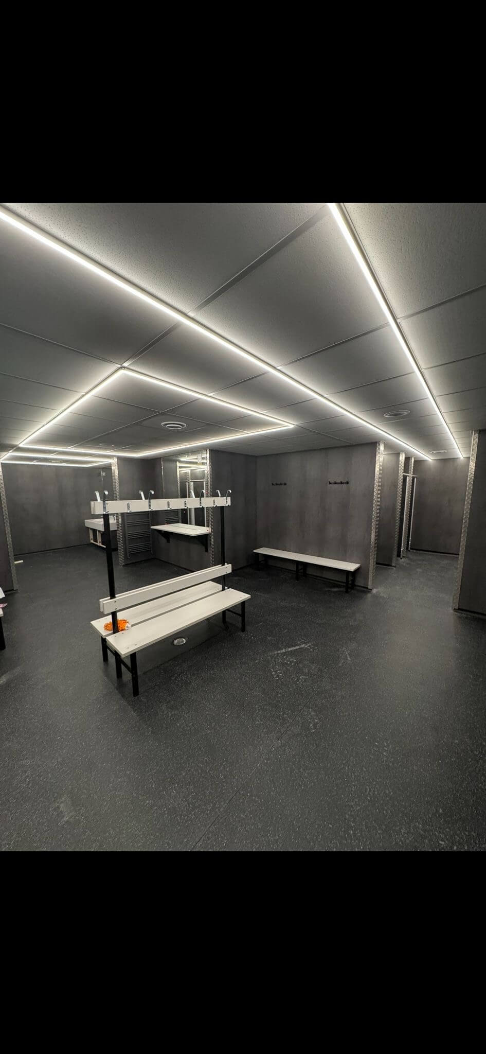 Durable dark safety flooring fitted in a commercial changing room